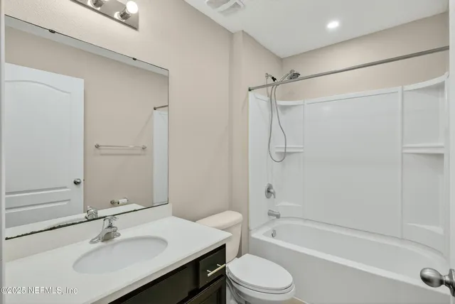 an empty room with closet and ceiling fan