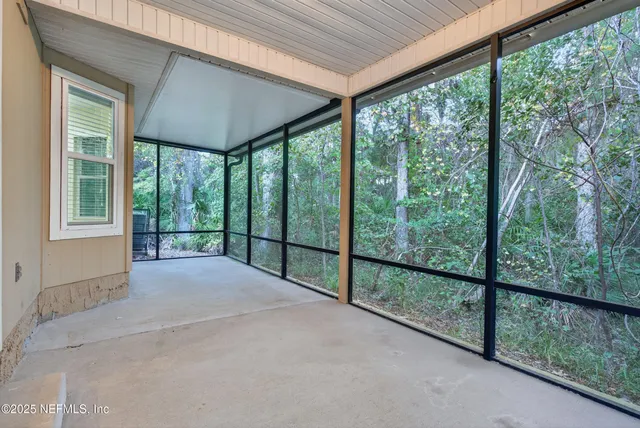 an empty room with windows and view