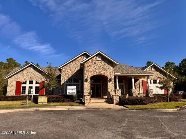 a living room with furniture gym equipment and a large window