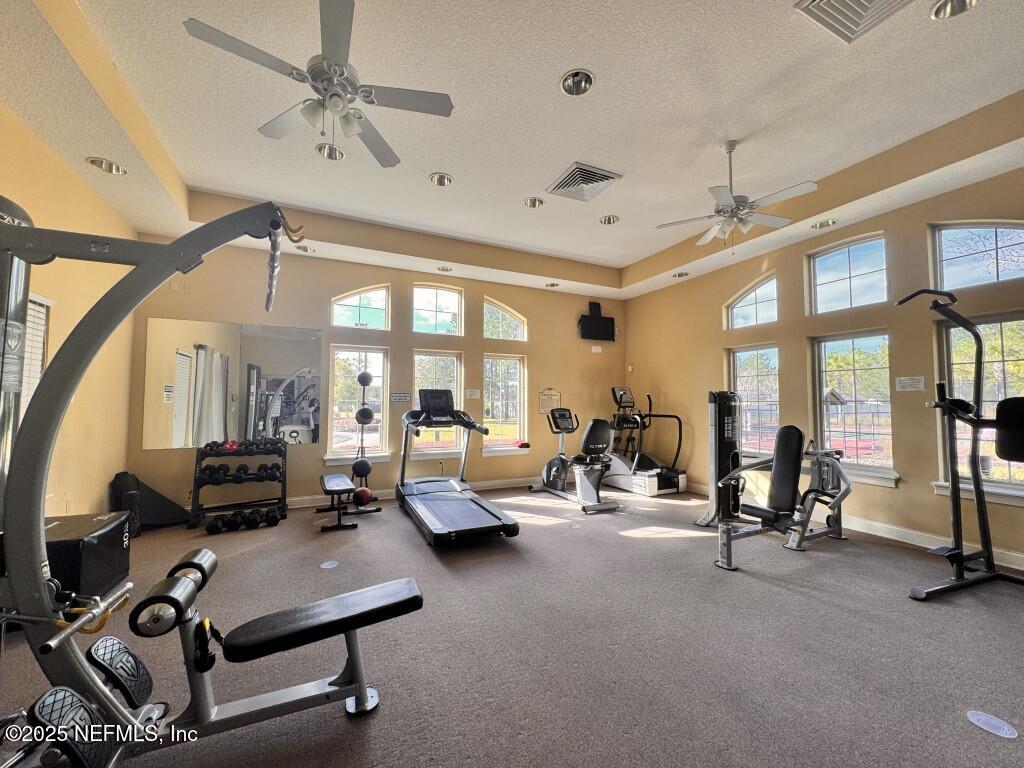 15885 Bainebridge Drive Jacksonville, FL 32218 - Photo 37 of 46 a living room with furniture gym equipment and a large window