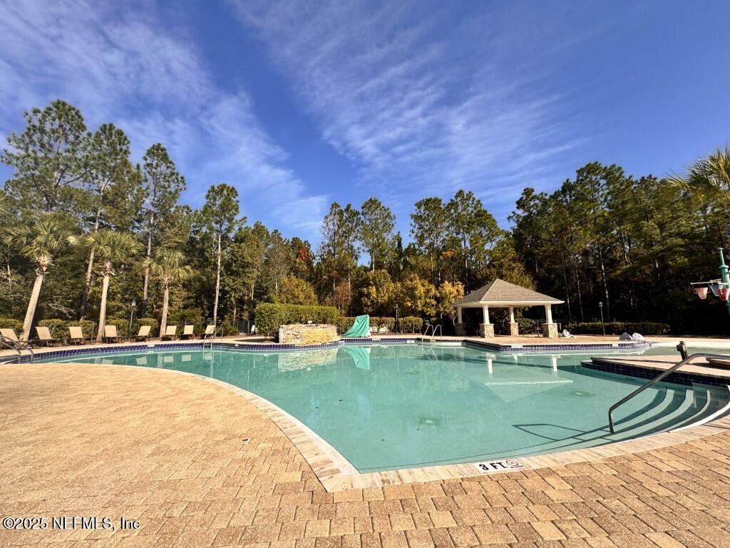 15885 Bainebridge Drive Jacksonville, FL 32218 - Photo 38 of 46 a view of swimming pool and trees in the background