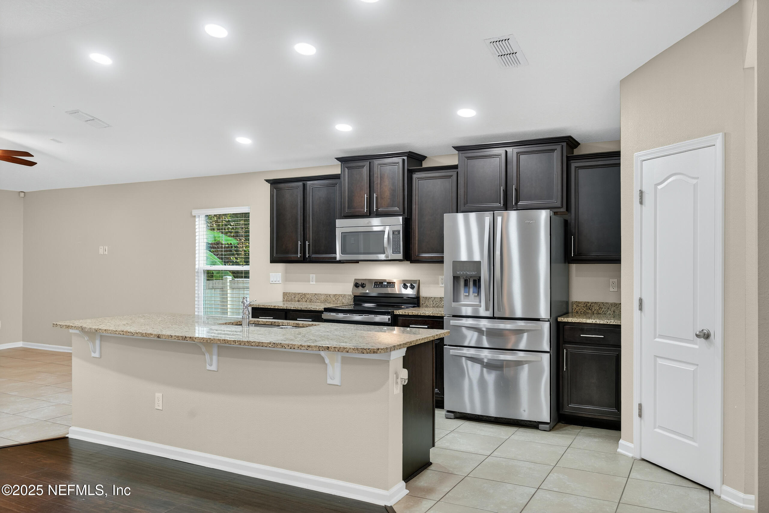 15885 Bainebridge Drive Jacksonville, FL 32218 - Photo 8 of 46 a kitchen with kitchen island stainless steel appliances cabinets a sink and a counter top