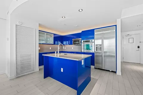 a kitchen with stainless steel appliances granite countertop a refrigerator a sink and a stove