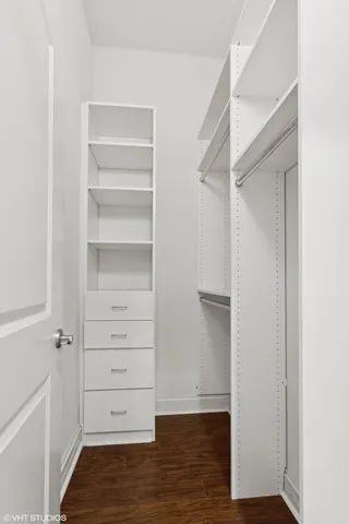 a view of walk in closet with empty racks