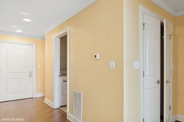 a view of a hallway with wooden floor