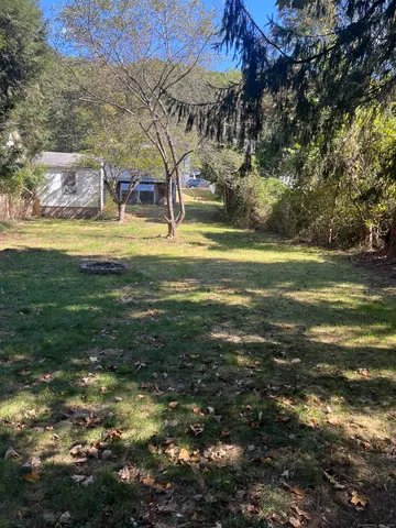 a view of a yard with swimming pool