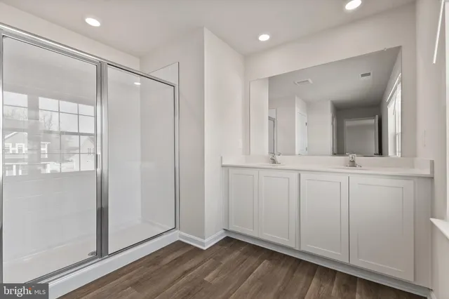 a bathroom with a mirror and a shower