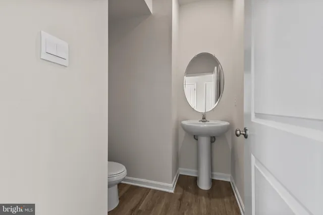 a bathroom with a toilet a sink and a window