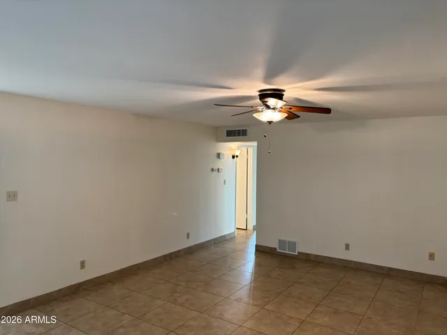a view of a livingroom with a ceiling fan and window
