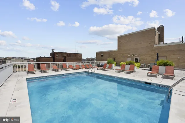 a view of a swimming pool with an outdoor seating