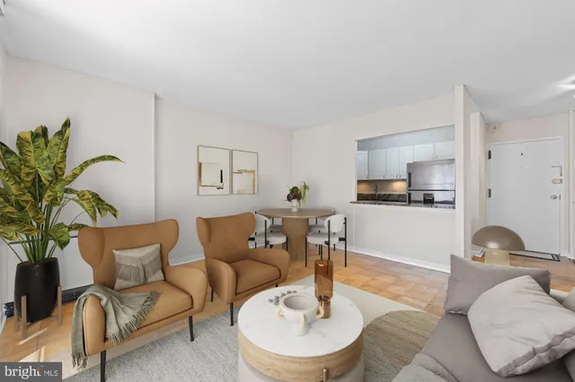 a living room with furniture potted plant and a table