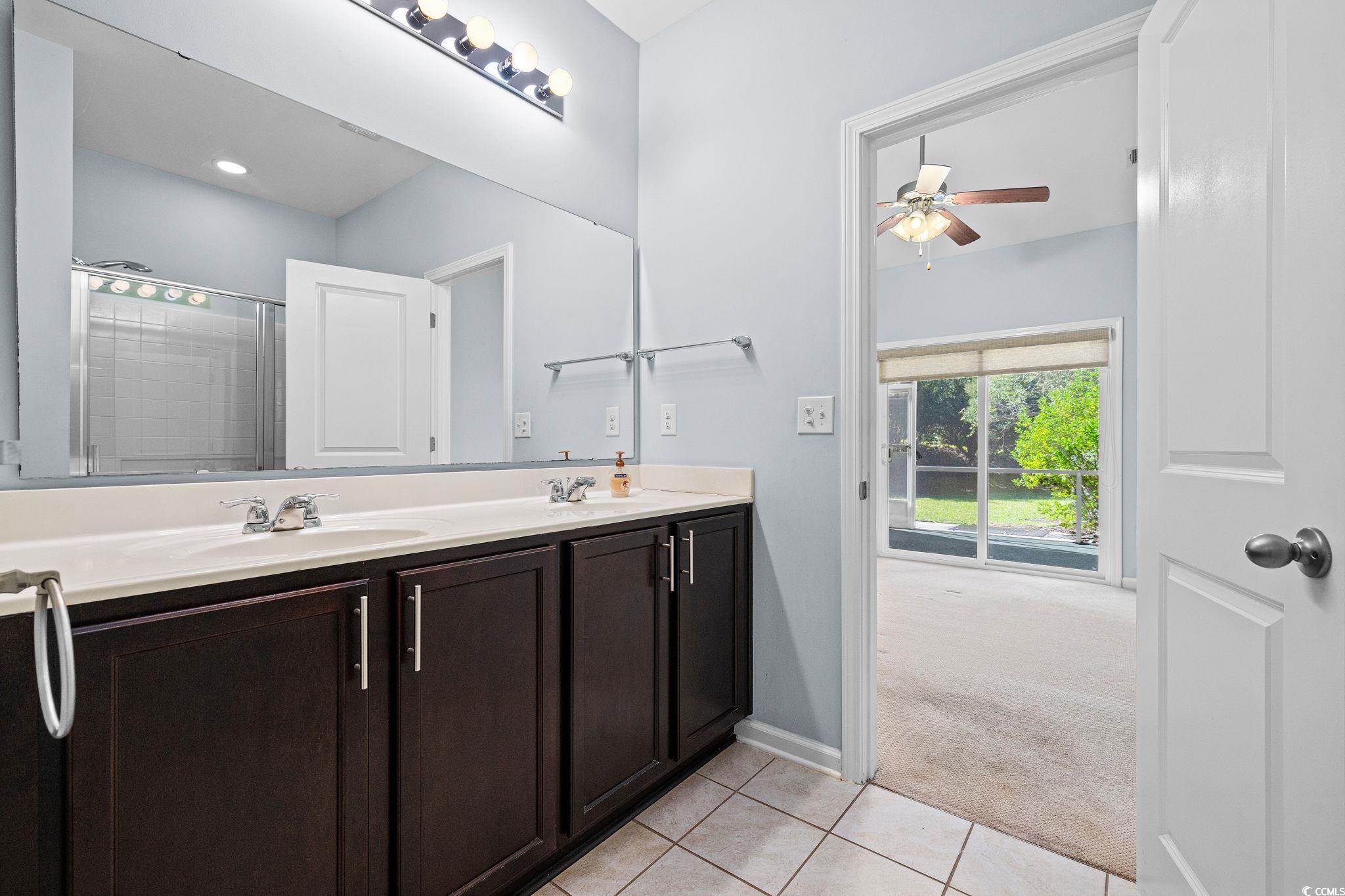 817 Arezzo Way, Unit 1001 Myrtle Beach, SC 29579 - Photo 25 of 40 Bathroom with light tile patterned floors, a shower stall, double vanity, light carpet, and a ceiling fan