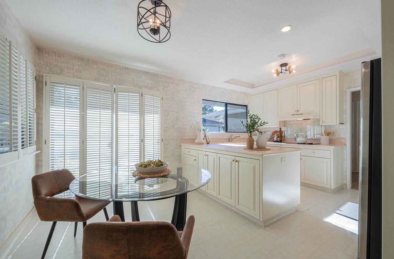 33 Country Club Gate Pacific Grove, CA 93950 - Photo 13 of 40 a kitchen with stainless steel appliances granite countertop a stove a sink a dining table and chairs