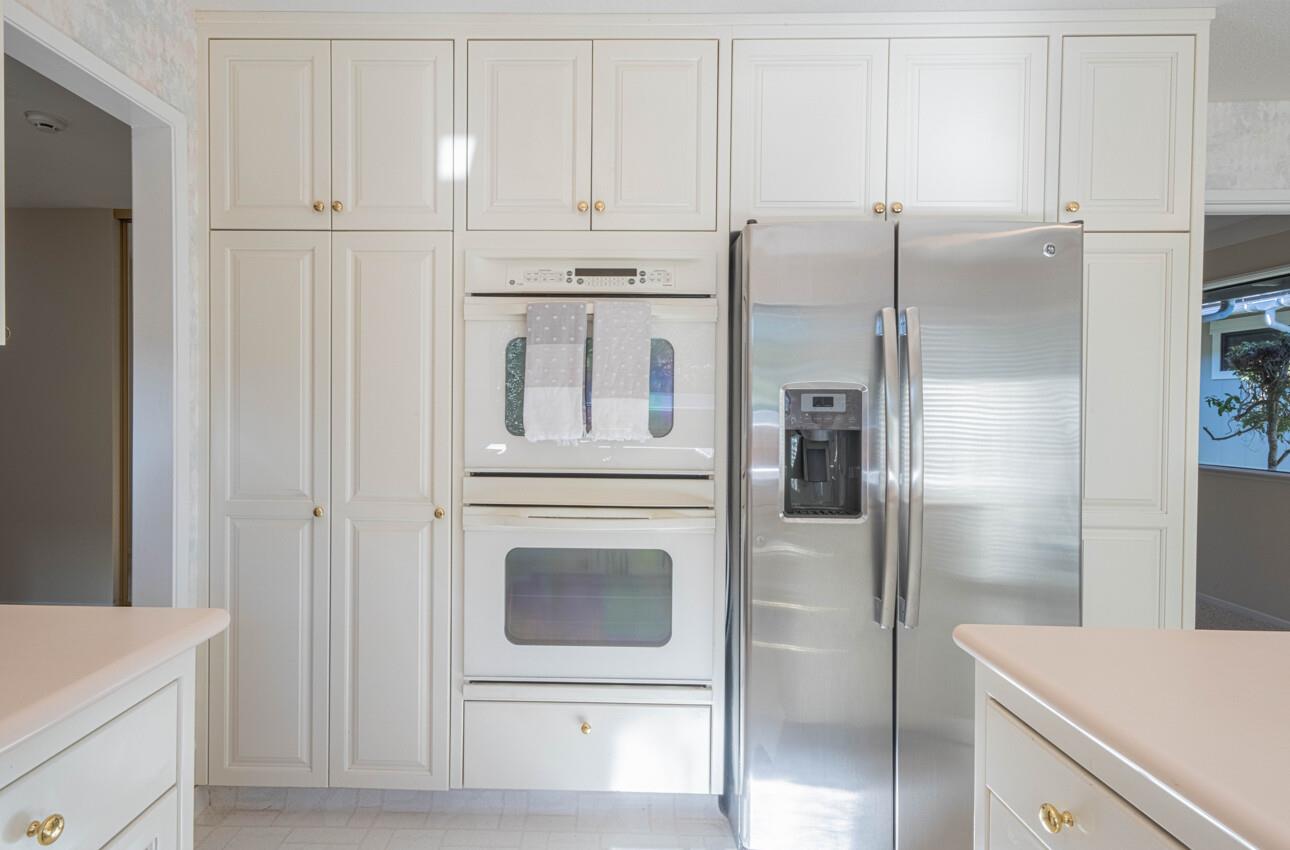 33 Country Club Gate Pacific Grove, CA 93950 - Photo 21 of 40 a kitchen with white cabinets and refrigerator