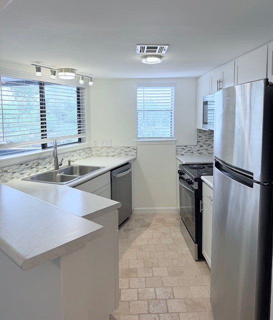 2500 Burleson Road, Unit 713 Austin, TX 78741 - Photo 3 of 15 A well-equipped kitchen provides modern amenities and practical surfaces for culinary pursuits.