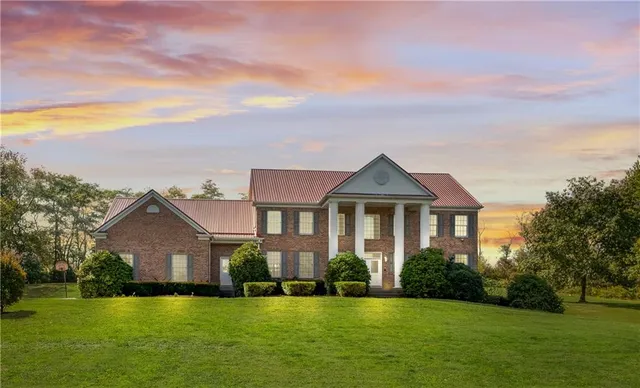 a front view of a house with a garden and yard