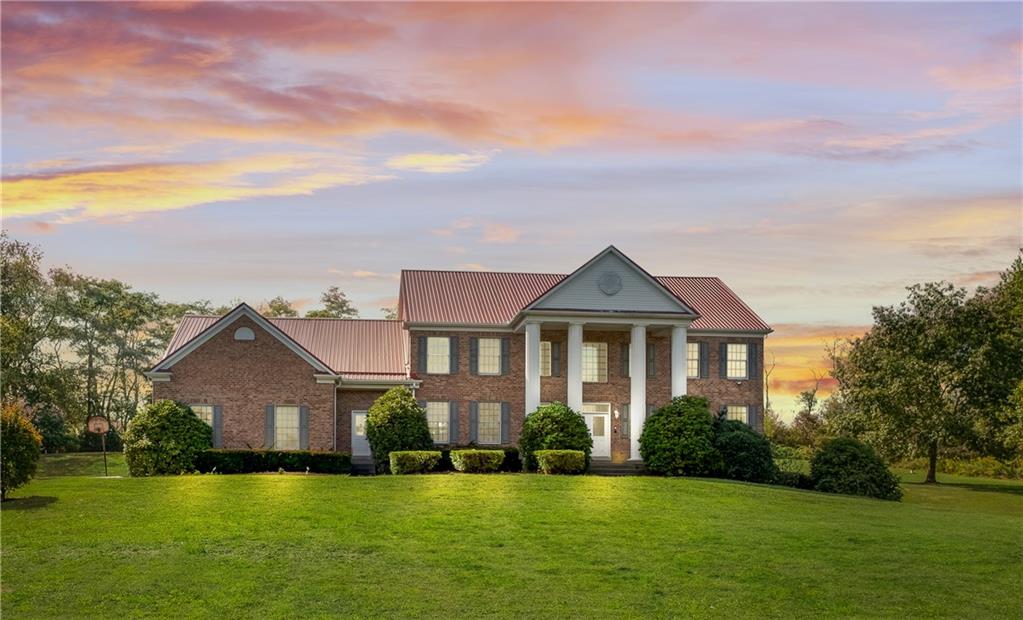 a front view of a house with a garden and yard