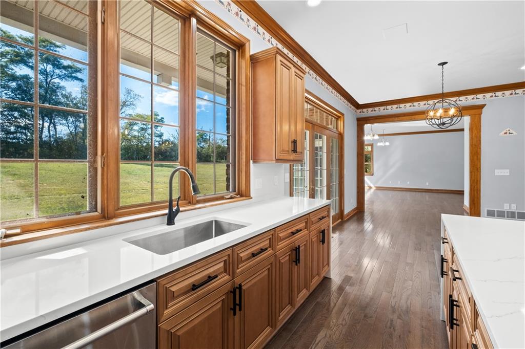 129 Purvis Road Butler, PA 16001 - Photo 13 of 50 a view of a kitchen with a sink and wooden floor