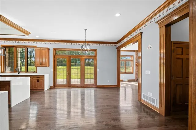 a view of an entryway with wooden floor and door