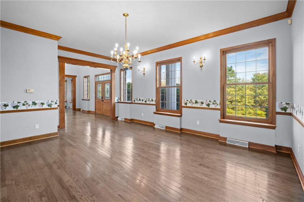 129 Purvis Road Butler, PA 16001 - Photo 18 of 50 a view of an empty room with window and wooden floor