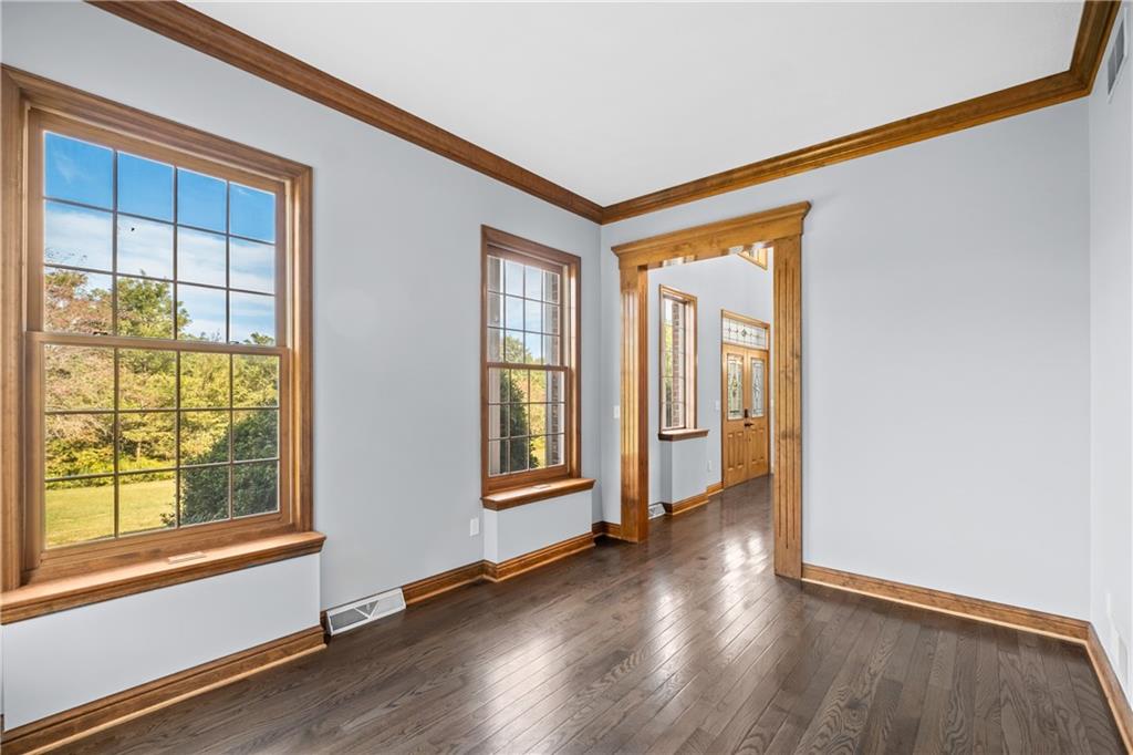 129 Purvis Road Butler, PA 16001 - Photo 23 of 50 a view of an empty room with wooden floor and a window