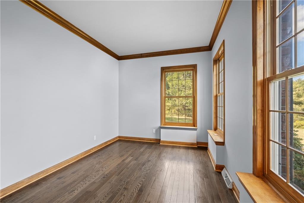129 Purvis Road Butler, PA 16001 - Photo 24 of 50 a view of an empty room with wooden floor and a window