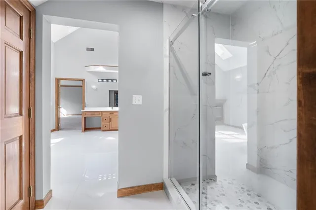 a view of a bathroom with a tub and shower