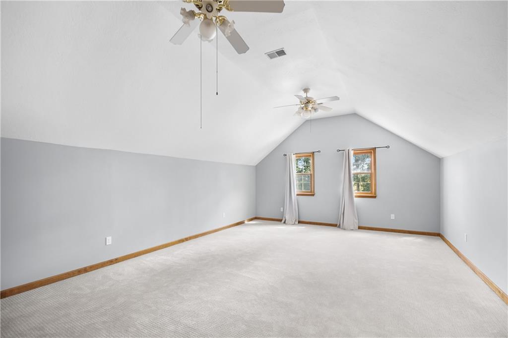 129 Purvis Road Butler, PA 16001 - Photo 36 of 50 an empty room with a ceiling fan and a window
