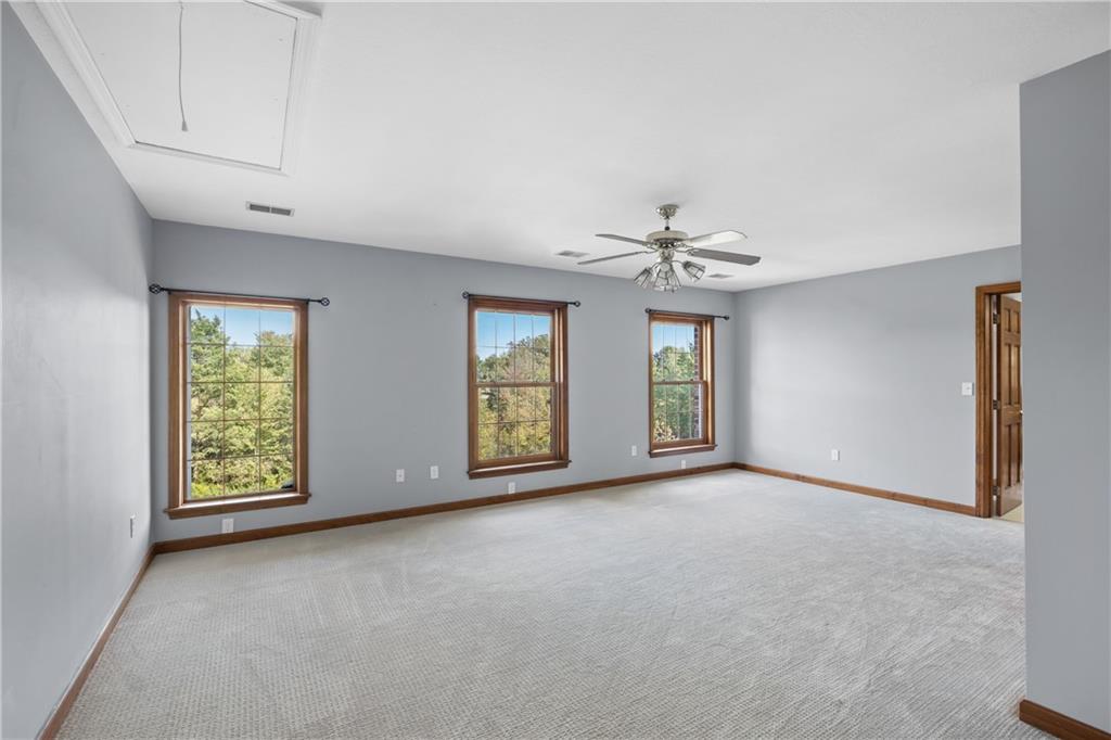 129 Purvis Road Butler, PA 16001 - Photo 40 of 50 a view of an empty room with window and chandelier fan