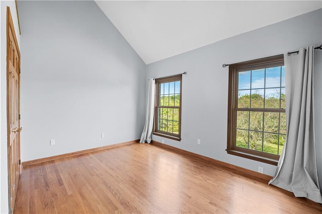 129 Purvis Road Butler, PA 16001 - Photo 44 of 50 an empty room with wooden floor and windows