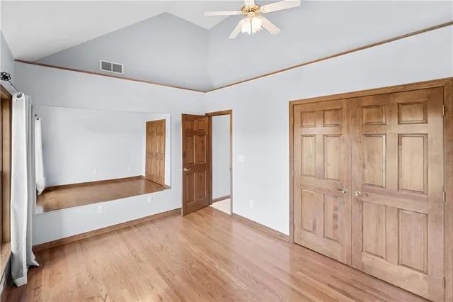 a view of an empty room with wooden floor