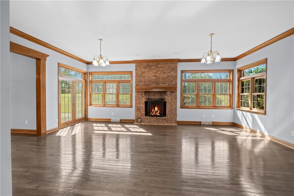 129 Purvis Road Butler, PA 16001 - Photo 7 of 50 a view of an empty room with wooden floor and a window