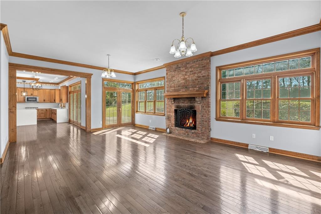 129 Purvis Road Butler, PA 16001 - Photo 8 of 50 a view of an empty room with wooden floor and a window