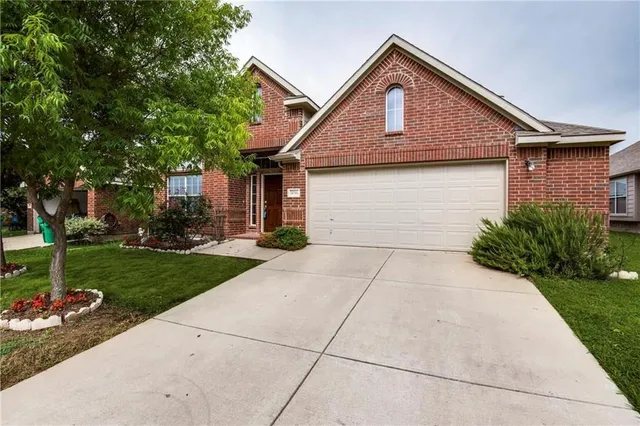 a front view of a house with yard