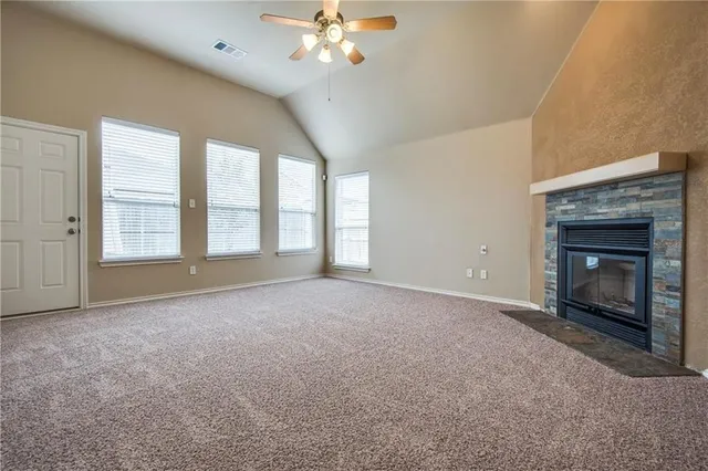 a view of an empty room with a fireplace