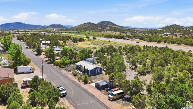 327 North Lodge Road Central, UT 84722 - Photo 29 of 45 Expansive parcel featuring a blue-sided residence, gravel driveway, and mature landscaping