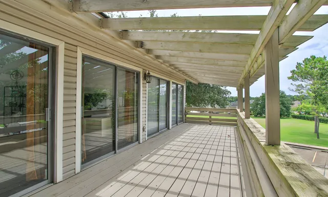 a view of a porch with wooden floor and city view