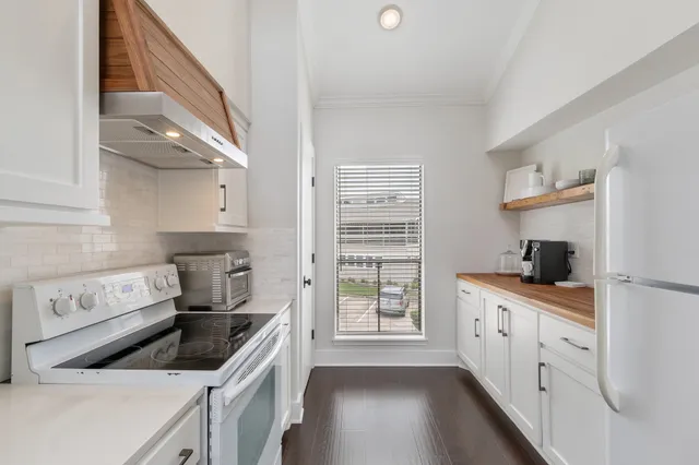 a kitchen with granite countertop a sink stove and cabinets