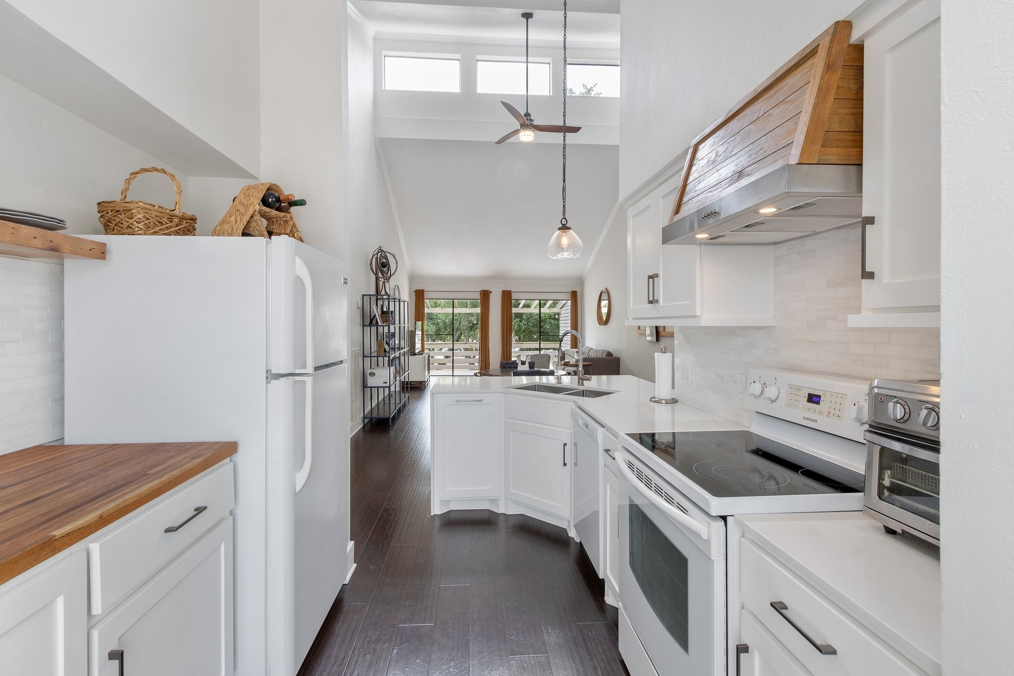 198 April Point Drive North Conroe, TX 77356 - Photo 18 of 34 a kitchen with a sink a refrigerator and a stove
