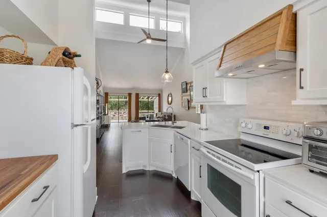 a kitchen with a sink a refrigerator and cabinets