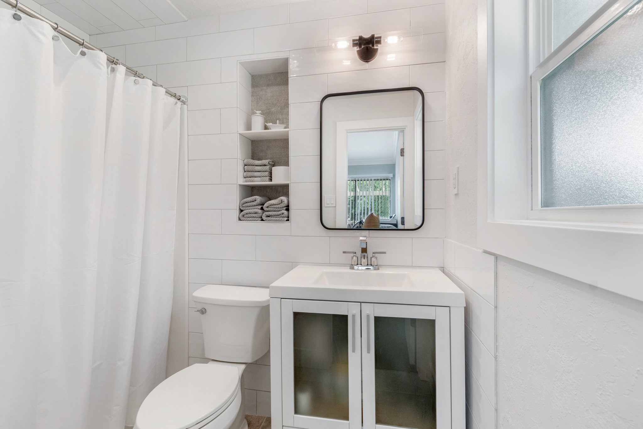 198 April Point Drive North Conroe, TX 77356 - Photo 24 of 34 a bathroom with a toilet sink and mirror