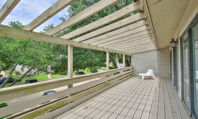 a view of a balcony with wooden floor