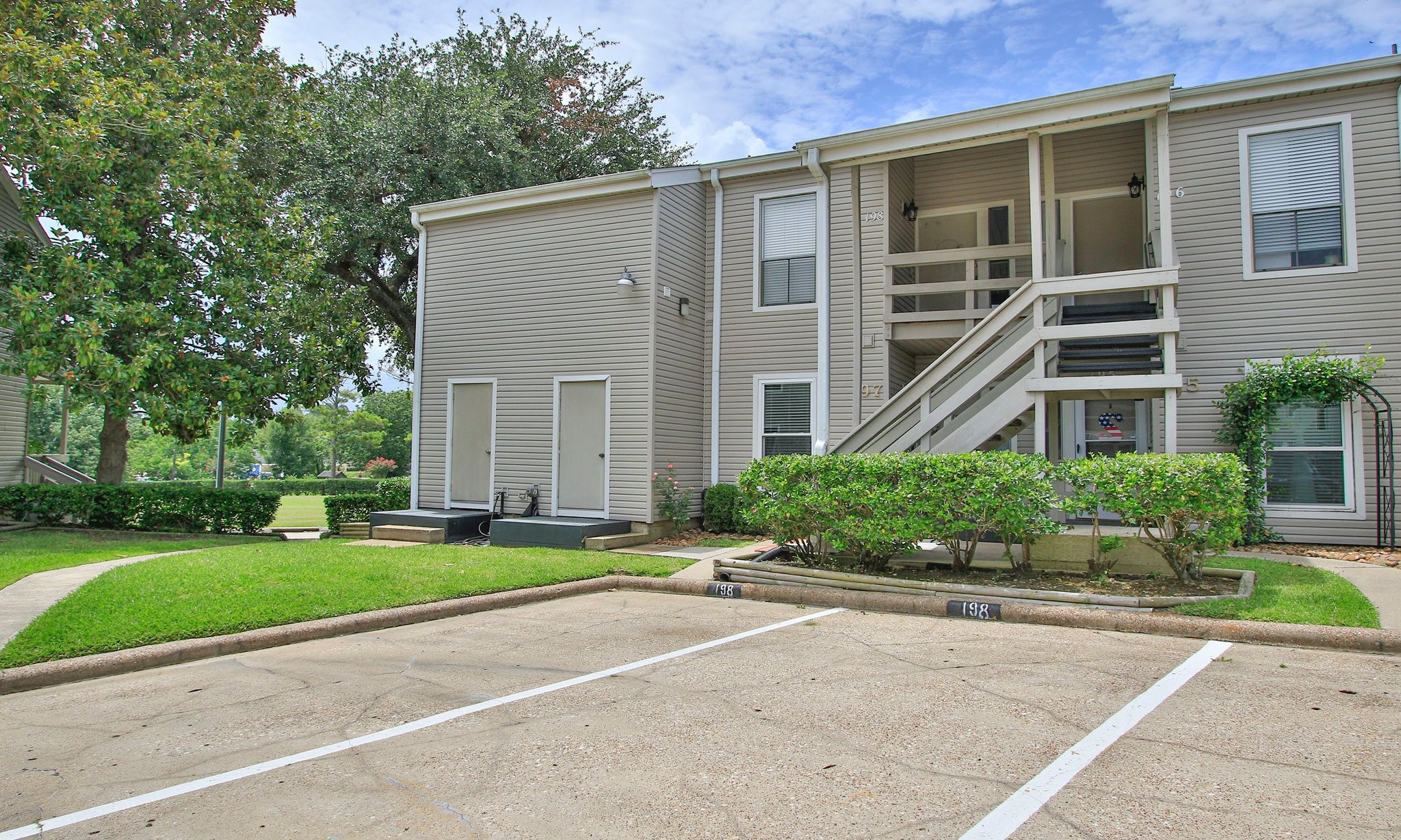 198 April Point Drive North Conroe, TX 77356 - Photo 4 of 34 a front view of a building with a garden and plants