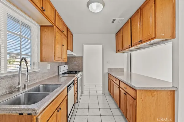 a kitchen with stainless steel appliances granite countertop a sink and a stove