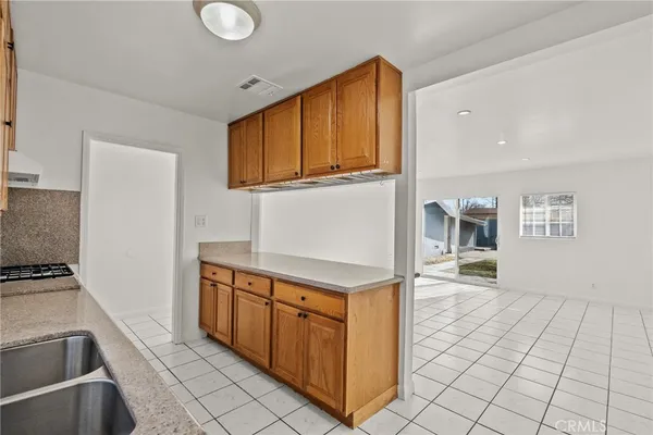a kitchen with stainless steel appliances granite countertop a stove and a sink