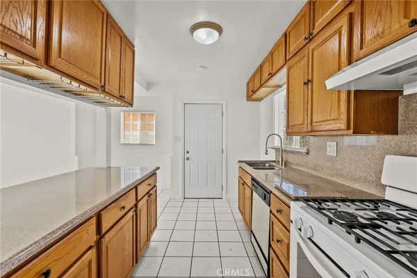 a kitchen with sink stove and cabinets