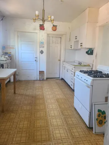 a kitchen with a sink cabinets and window