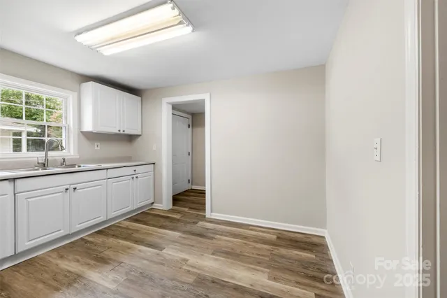 a kitchen with granite countertop white cabinets and white appliances