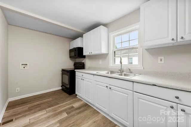 a kitchen with sink cabinets and window
