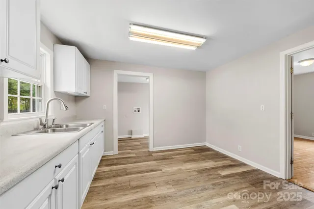 a spacious bathroom with a sink and a window